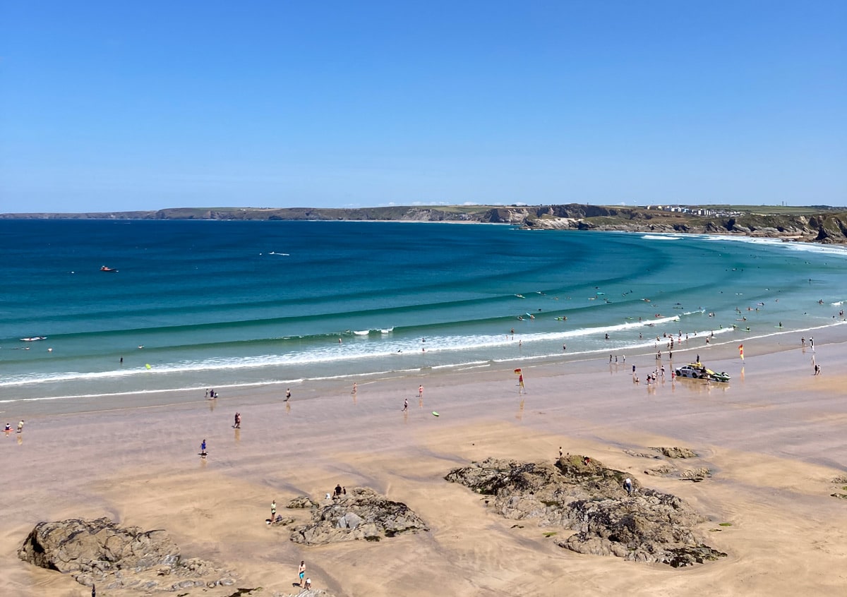 Waves onto the beach at Newquay with the best surf schools in the UK